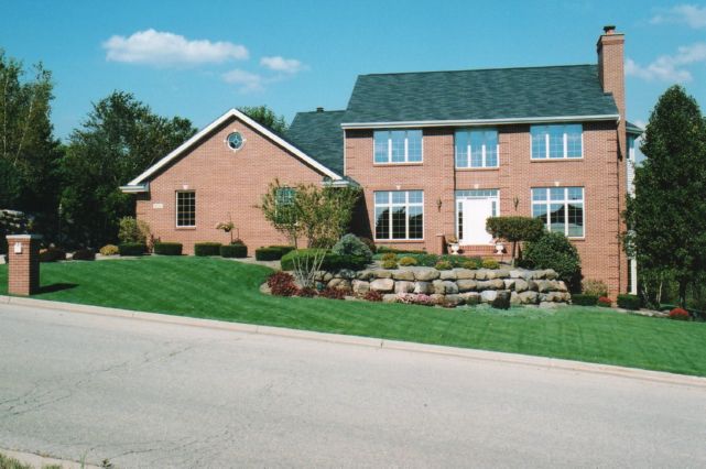 Brick two story home on a sloping lot